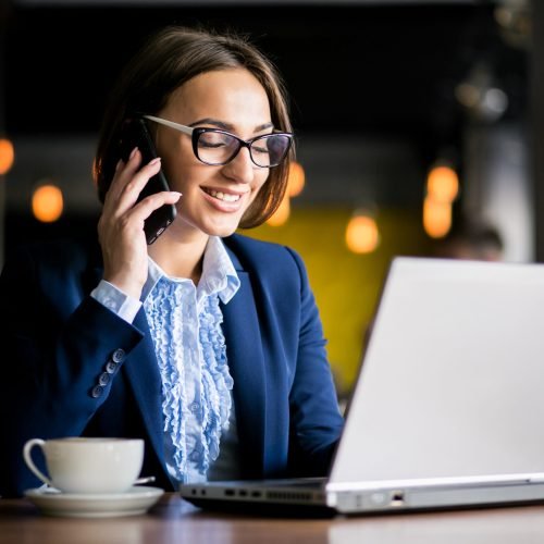 Business woman working in a cafe